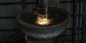 a close up of a fountain with water pouring from it