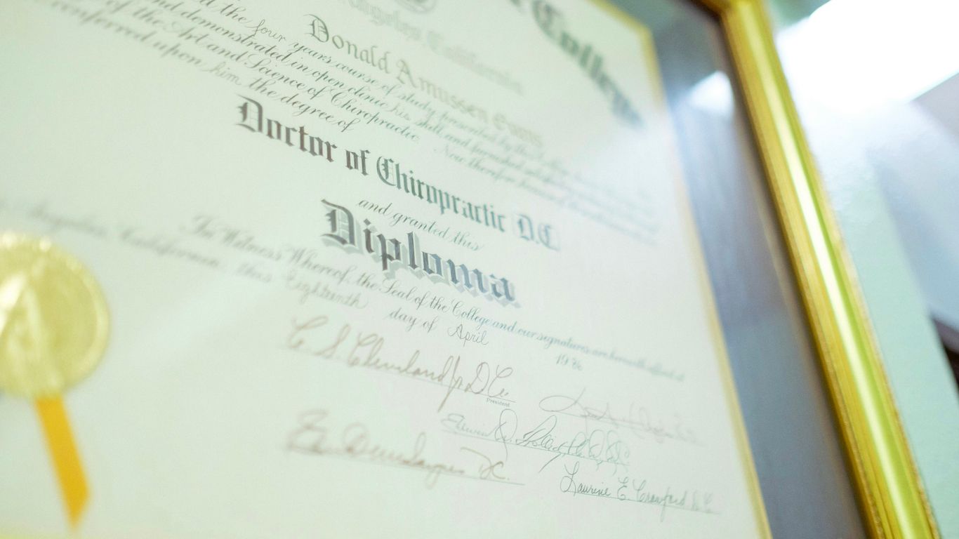 a framed diploma with a gold seal on it