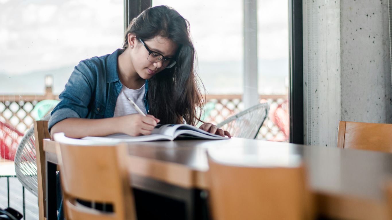 woman writing on book