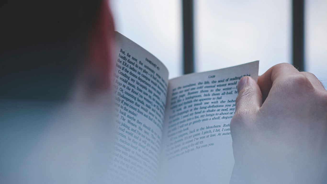 a hand holding a book